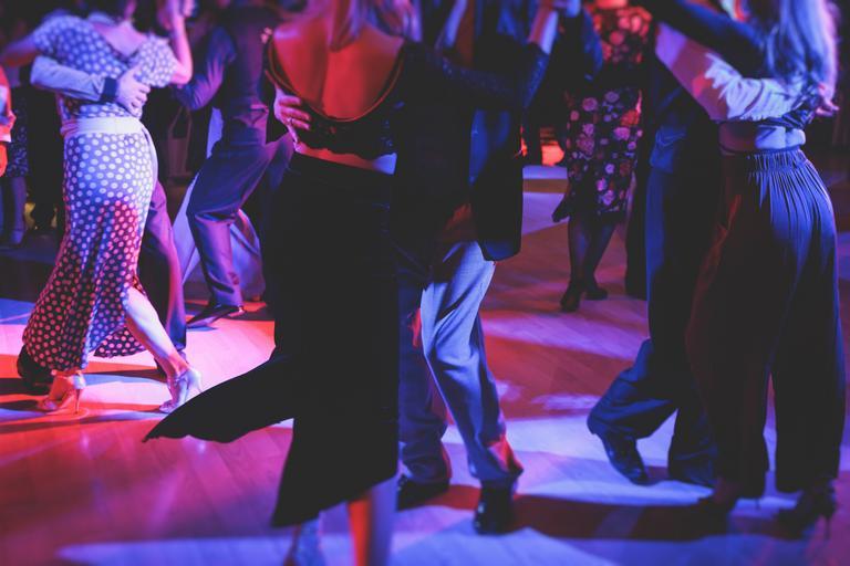 Paare tanzen traditionellen lateinischen argentinischen Tanz milonga im Ballsaal auf einem Festival, Tango-Studio, Salsa, Bachata und Kizomba Lektion in der roten und lila Lichter, Probe in Tanzkurs